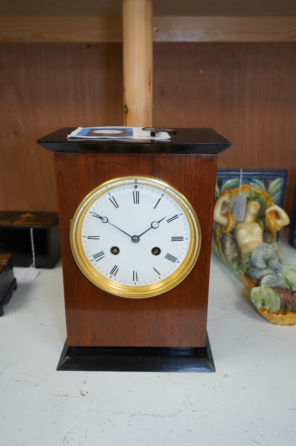 A George V mahogany and ebonised eight day movement mantel clock, 27cm high. Condition - good - No bell.